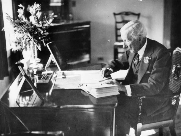 American oil magnate and philanthropist, John Davidson Rockefeller at work in his study.