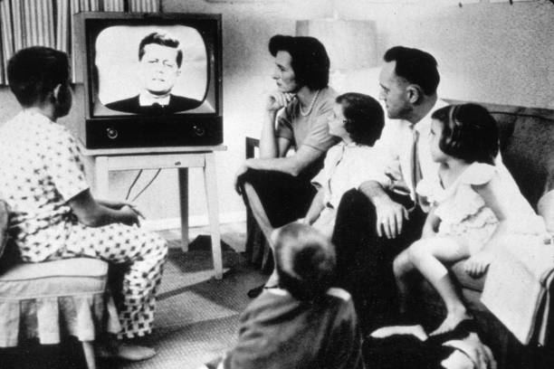 circa-1962-a-family-watching-president-john-kennedy-on-television-picture-id3094017