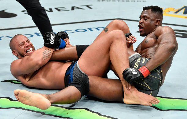 Ciryl Gane of France attempts to secure a heel hook submission against Francis Ngannou of Cameroon in their UFC heavyweight championship fight during...
