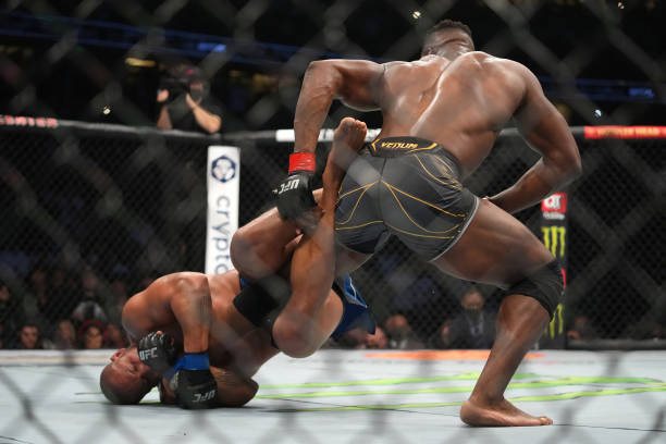 Ciryl Gane of France attempts to secure a heel hook submission against Francis Ngannou of Cameroon in their UFC heavyweight championship fight during...
