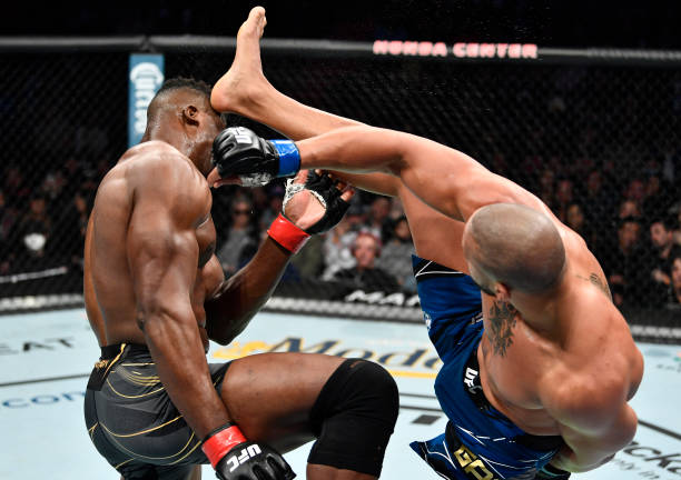 Ciryl Gane of France kicks Francis Ngannou of Cameroon in their UFC heavyweight championship fight during the UFC 270 event at Honda Center on...
