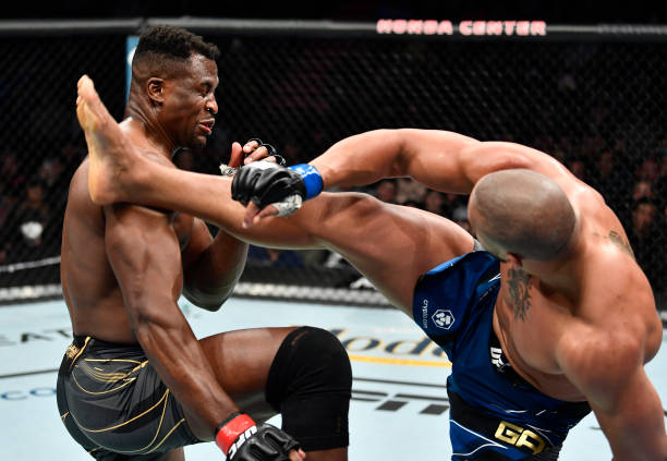 Ciryl Gane of France kicks Francis Ngannou of Cameroon in their UFC heavyweight championship fight during the UFC 270 event at Honda Center on...