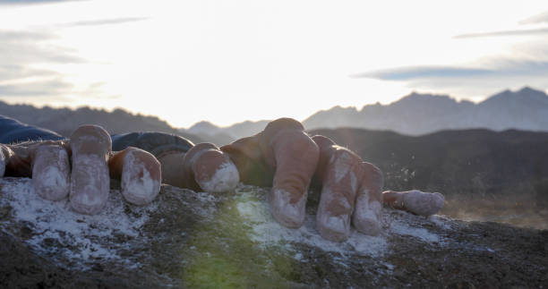 Close up of mountaineer&#039;s hands climbing up boulder