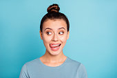 Close up photo beautiful amazing she her lady look side empty space licking tongue upper lip crazy silly mischief carefree mood giggling wear casual sweater pullover isolated blue bright background