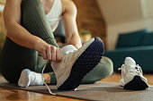 Close-up of athletic woman putting on sneakers.