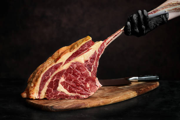 closeup of meat on cutting board over black background picture id1387497173?k=20&m=1387497173&s=612x612&w=0&h=gl4TmbLj9oIMk