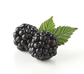 Close-up of two fresh blackberry with leaves
