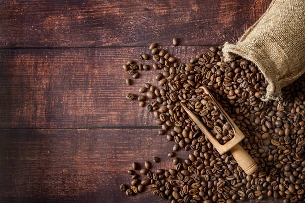coffee beans roasted in a sack with scoop on wooden table background picture id1132158144?k=20&m=1132158144&s=612x612&w=0&h=R9gT 1W5ySZv6cw QlqWkc9qfCkhauDIVH1IqjeGnEI=