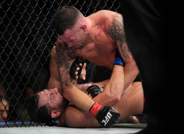 Colby Covington punches Jorge Masvidal in their welterweight fight during the UFC 272 event on March 05, 2022 in Las Vegas, Nevada.