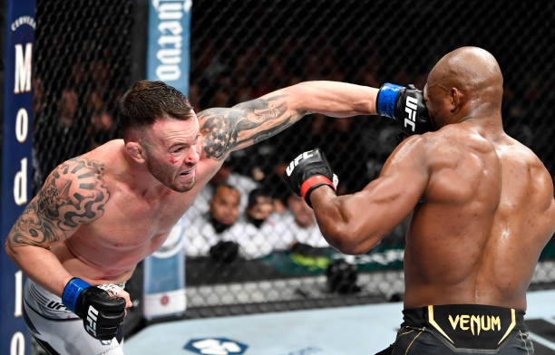 Colby Covington punches Kamaru Usman of Nigeria in their UFC welterweight championship fight during the UFC 268 event at Madison Square Garden on...