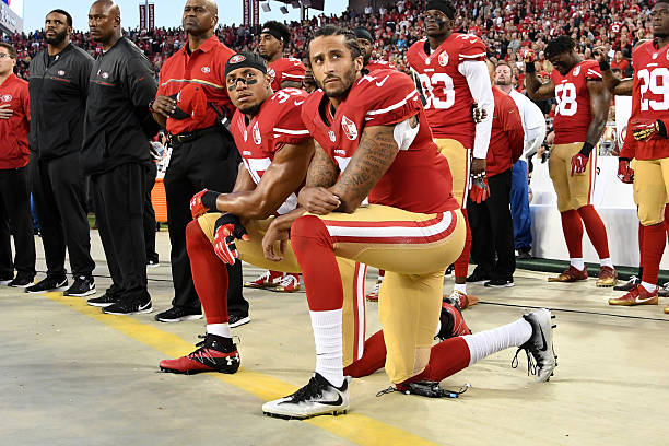 Colin Kaepernick and Eric Reid of the San Francisco 49ers kneel in protest during the national anthem prior to playing the Los Angeles Rams in their...
