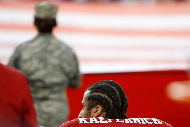 Colin Kaepernick of the San Francisco 49ers kneels in protest during the national anthem prior to playing the Los Angeles Rams in their NFL game at...