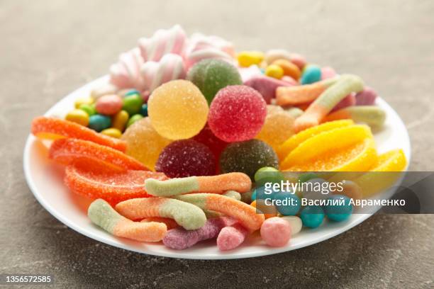 colorful candies lollipops jelly plate grey