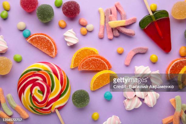 colorful candies lollipops jelly purple background