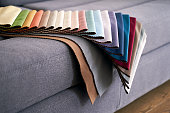 Colorful upholstery fabric samples on the home sofa