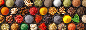 Colourful background from various herbs and spices for cooking in bowls