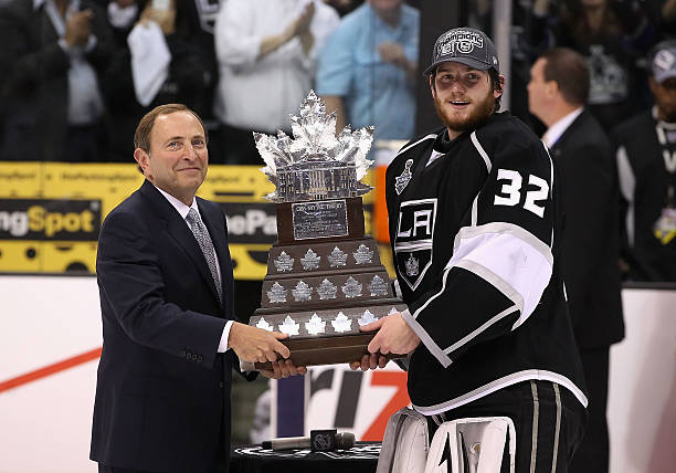 Commissioner Gary Bettman of the National Hockey League presents the Conn Smythe Trophy to Jonathan Quick of the Los Angeles Kings after defeating...