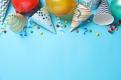Composition with different birthday accessories on blue background, space for text
