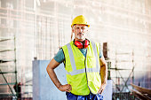 Confident architect standing at construction site