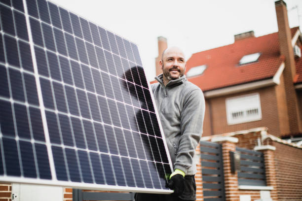construction worker installing solar panels