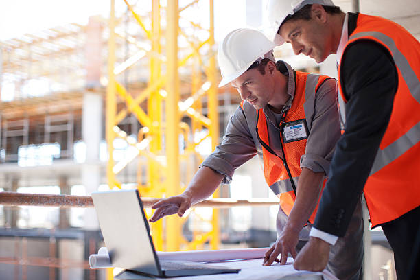 construction workers using laptop on construction site - construction wifi stock pictures, royalty-free photos & images