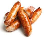 Cooked sausage piled together with a white background