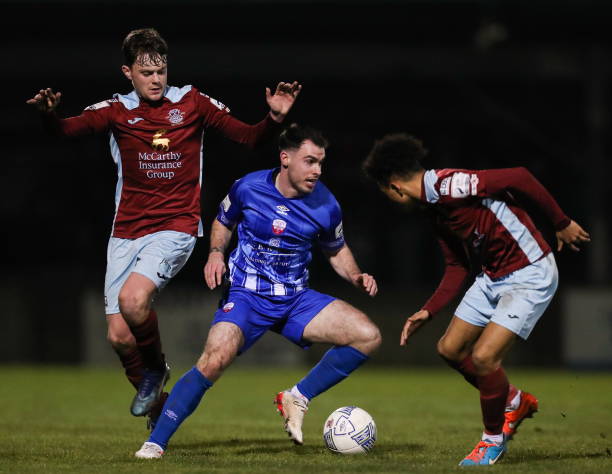 Cork , Ireland - 4 March 2022; Joel Coustrain of Treaty United in action against Jack Larkin, left, and Issa Kargbo of Cobh Ramblers during the SSE...