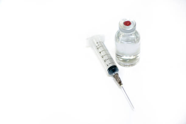 Coronavirus or COVID-19, 2019 - nCoV vaccine in a bottle with syringe and protective gloves and face mak on the table prepared for vaccinating.