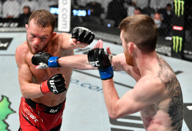Cory Sandhagen punches Petr Yan of Russia in the UFC interim bantamweight championship fight during the UFC 267 event at Etihad Arena on October 30,...