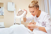 Cosmetologist is a professional with a patient in the office of