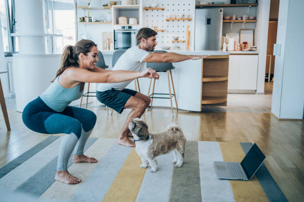 couple exercising together at home. - squats stock pictures, royalty-free photos & images