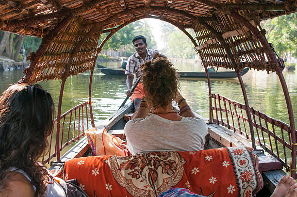 a couple on a guided boat ride in india. - sightseeing tour kerala stock pictures, royalty-free photos & images