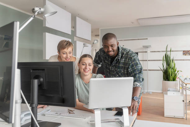 coworkers working together using computer - black software developer stock pictures, royalty-free photos & images