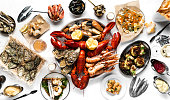 Crayfish and seafood table top view. Lobsters, crayfish, shrimps, clams, oysters, sushi