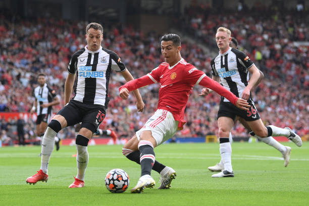 Cristiano Ronaldo of Manchester United shoots whilst under pressure from Javier Manquillo of Newcastle United during the Premier League match between...