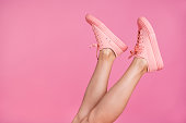 Cropped close-up image view photo of nice attractive feminine fit thin slim shaven legs active sport walk go steps trendy foot-wear isolated over pink pastel background