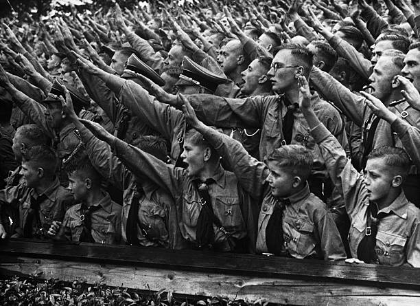 Crowds of Hitler Youth salute as they listen to a speech given by Adolf Hitler the Nazi leader at a rally at the Nuremberg Stadium in Germany 1937