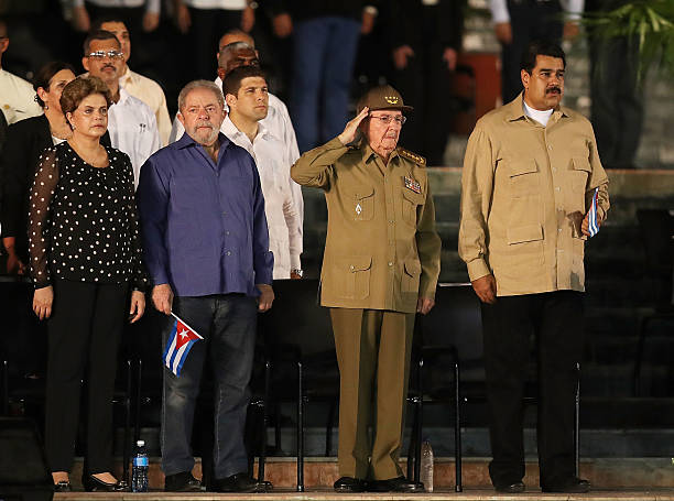 Cuban President Raul Castro salutes during the Cuban National Anthem as he stands with Brazilian impeached former president Dilma Rousseff former...