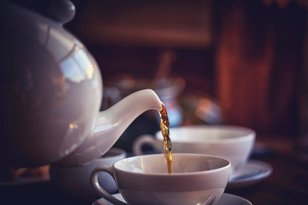 cup of black tea served with biscuits - tea pot stock pictures, royalty-free photos & images