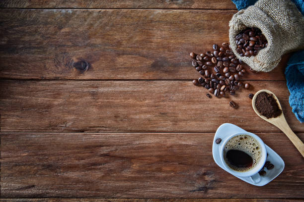 cup of espresso with coffee beans on rustic wooden table picture