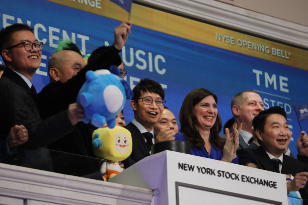 Cussion Kar Shun Pang, CEO of Tencent Music Entertainment, rings the opening bell of the New York Stock Exchange as the Chinese music-streaming...