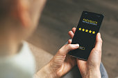 customer feedback - woman using phone to give 5 star rating for good service