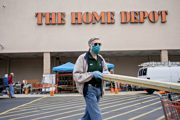 customer wears a protective mask while pushing a cart outside a home picture