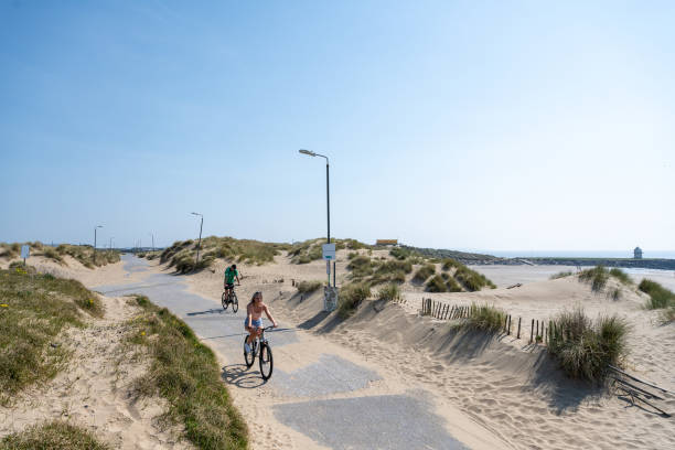 Cyclists on Trecco Bay seafront on April 10, 2020 in Porthcawl, United Kingdom. Police have stepped up patrols to prevent people from travelling to...
