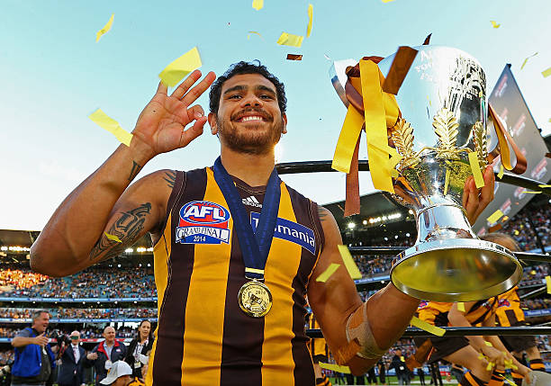 Cyril Rioli of the Hawks celebrates with the Premeirship Cup during the 2014 AFL Grand Final match between the Sydney Swans and the Hawthorn Hawks at...