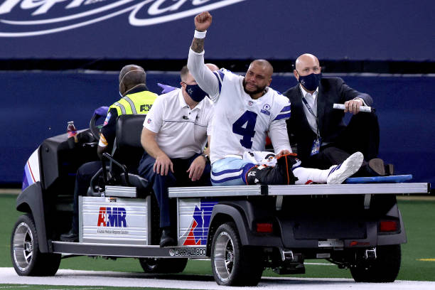 dak-prescott-of-the-dallas-cowboys-is-carted-off-the-field-after-a-picture-id1279709063