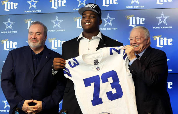 Dallas Cowboys first round draft pick Tyler Smith, center, is one of three rookie competing for starting jobs.