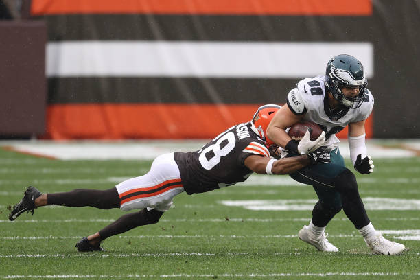 Dallas Goedert of the Philadelphia Eagles is pursued by Kevin Johnson of the Cleveland Browns during the first half at FirstEnergy Stadium on...