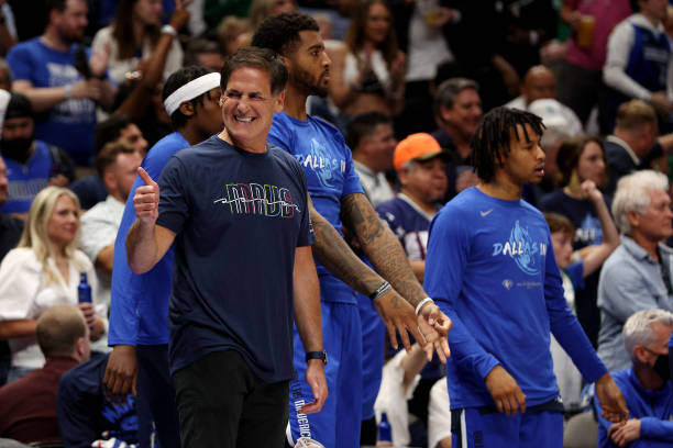 Dallas Mavericks owner Mark Cuban celebrates a three point basket during the second quarter against the Golden State Warriors in Game Three of the...