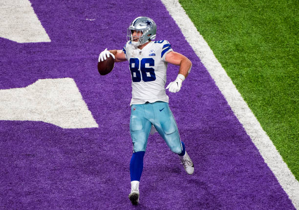 Dalton Schultz of the Dallas Cowboys scores the go-ahead touchdown in the fourth quarter of the game against the Minnesota Vikings at U.S. Bank...